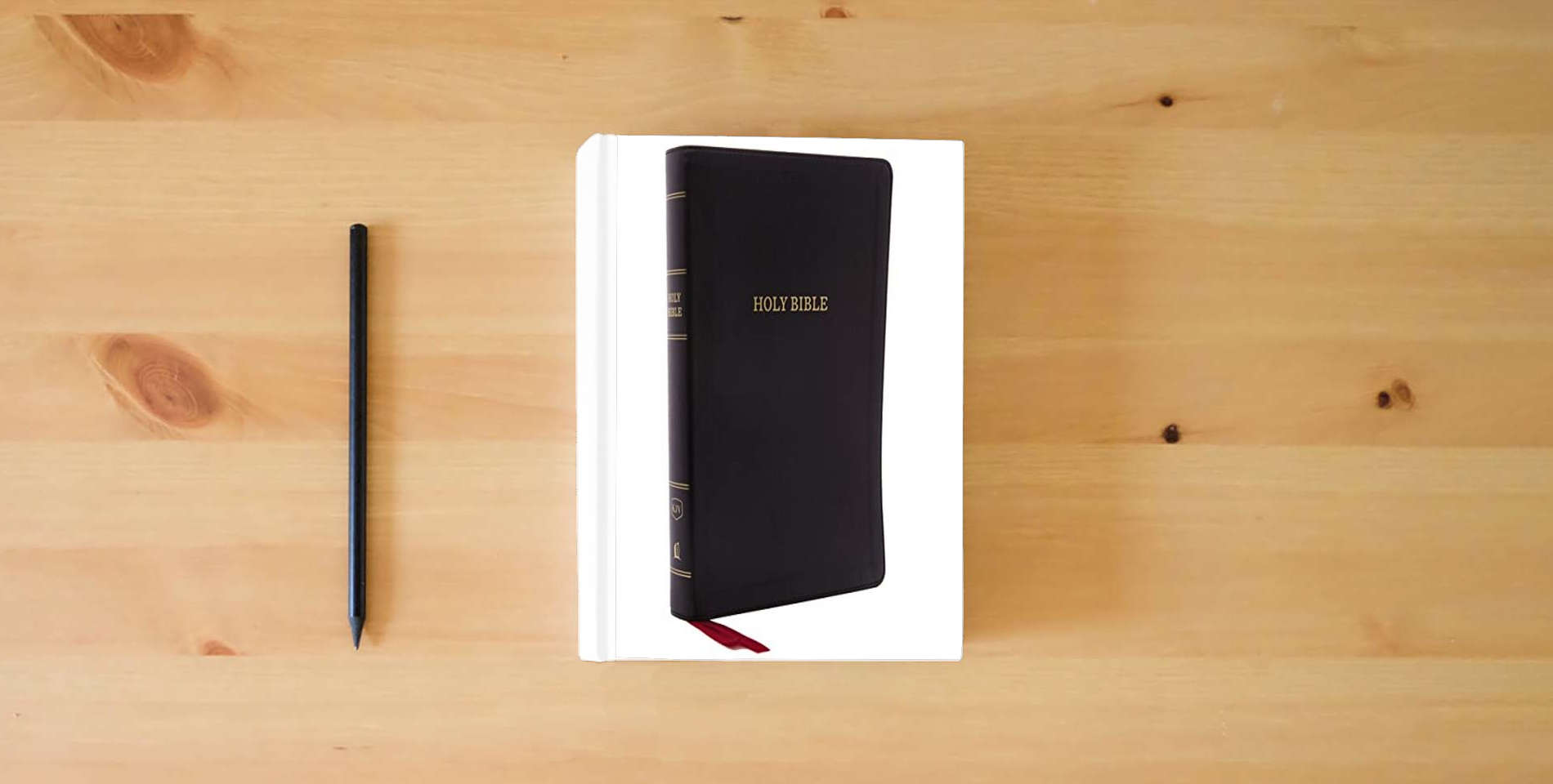 The book KJV Holy Bible: Giant Print with 53,000 Cross References, Deluxe Black Leathersoft, Red Letter, Comfort Print: King James Version is on the table