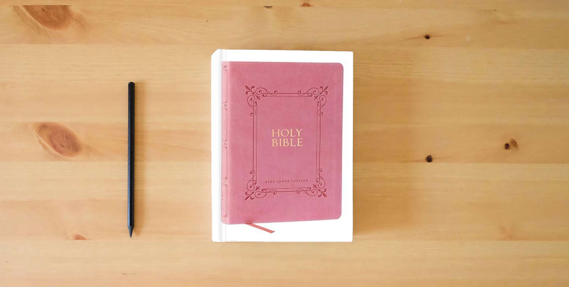 The book KJV Holy Bible: Large Print with 53,000 Center-Column Cross References, Pink Leathersoft, Red Letter, Comfort Print: King James Version is on the table