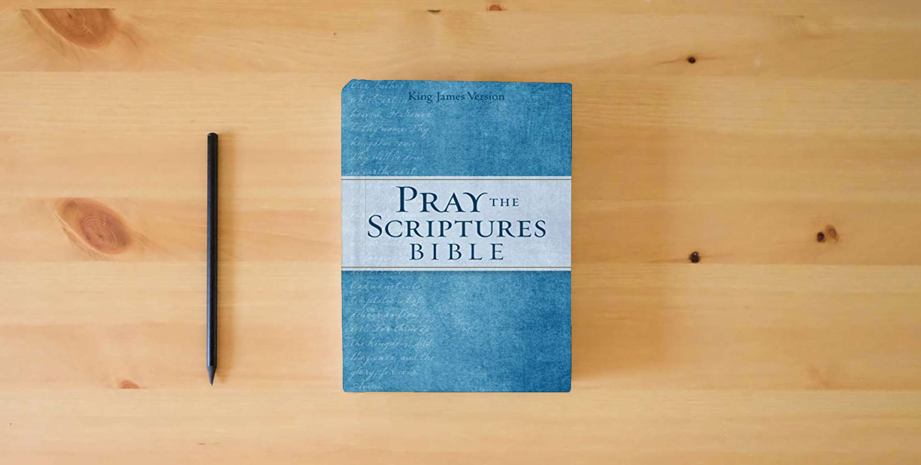 The book KJV Pray the Scriptures Bible is on the table