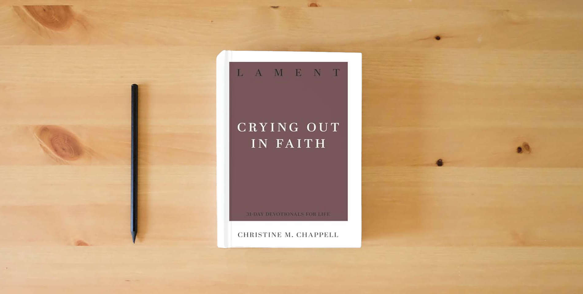 The book Lament: Crying Out in Faith (31-Day Devotionals for Life) is on the table