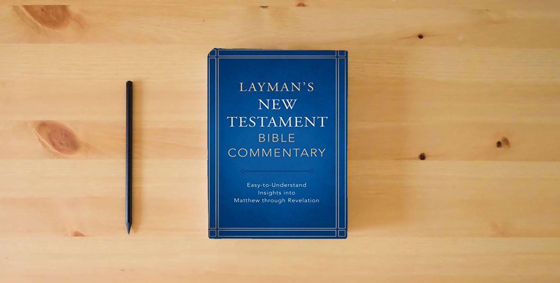 The book Layman's New Testament Bible Commentary: Easy-to-Understand Insights into Matthew through Revelation is on the table