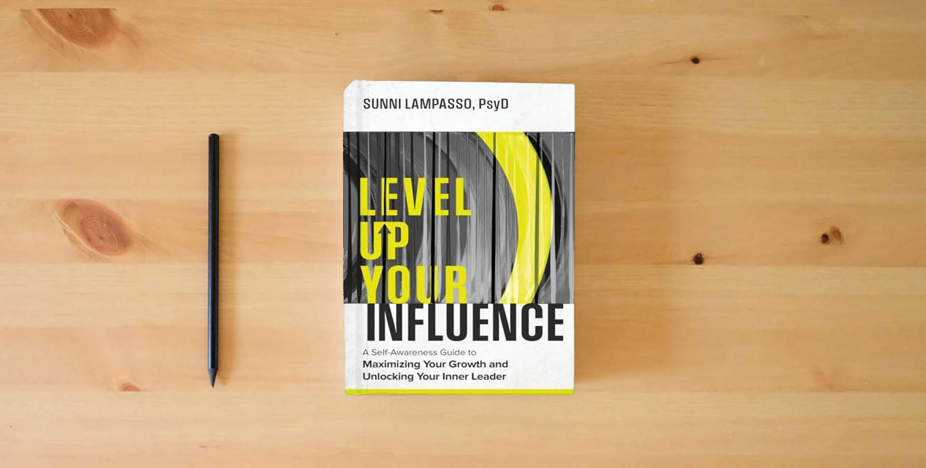 The book Level Up Your Influence: A Self-Awareness Guide to Maximizing Your Growth and Unlocking Your Inner Leader is on the table