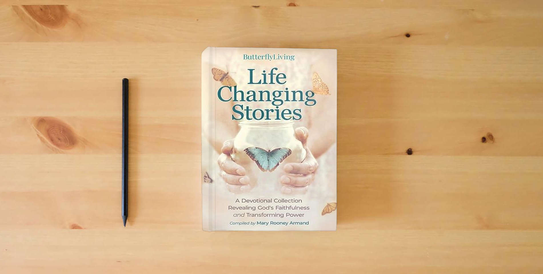 The book Life Changing Stories: A Devotional Collection Revealing God's Faithfulness and Transforming Power is on the table