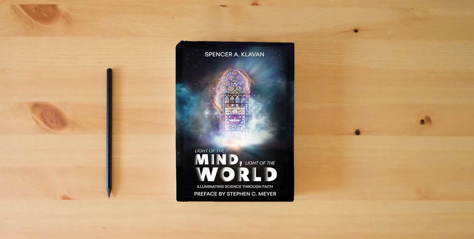 The book Light of the Mind, Light of the World: Illuminating Science Through Faith is on the table