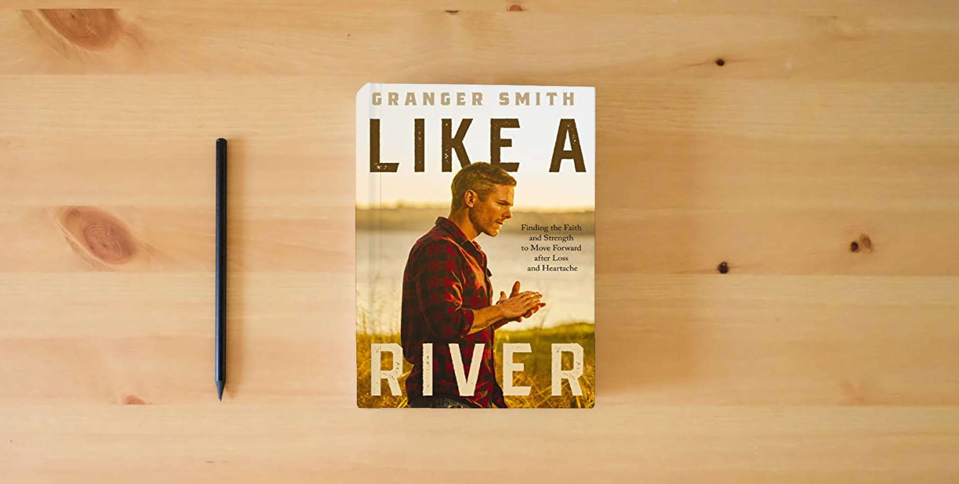 The book Like a River: Finding the Faith and Strength to Move Forward after Loss and Heartache is on the table