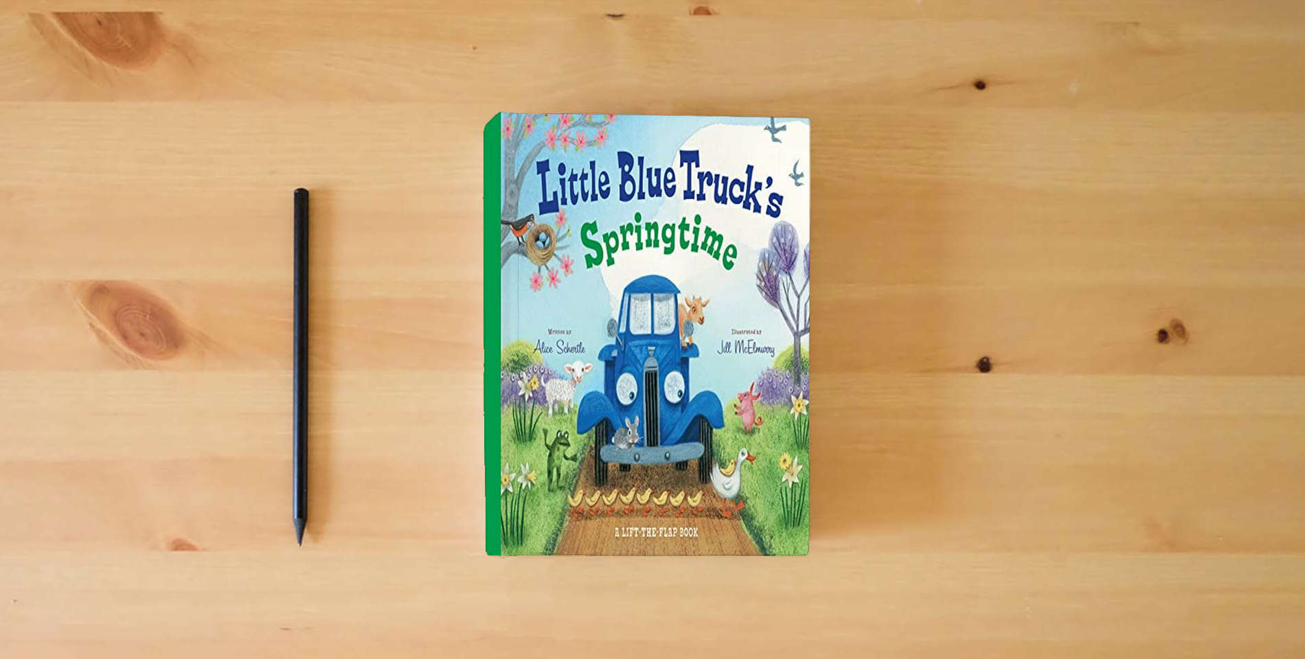 The book Little Blue Truck's Springtime: An Easter And Springtime Book For Kids is on the table