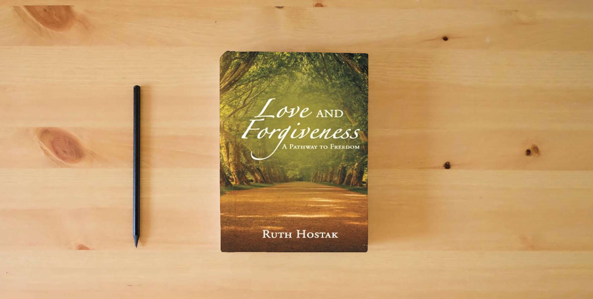 The book Love and Forgiveness: A Pathway to Freedom is on the table