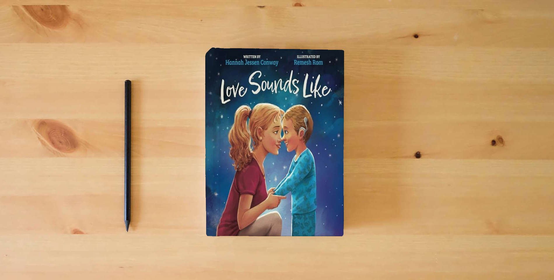 The book Love Sounds Like: A Children's Bedtime Book About Hearing Loss and the Different Ways Kids Experience Love is on the table