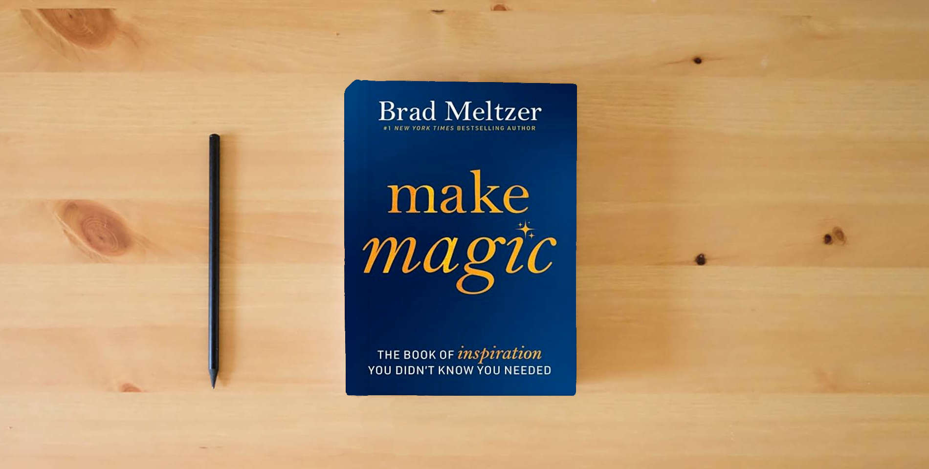 The book Make Magic: The Book of Inspiration You Didn't Know You Needed is on the table