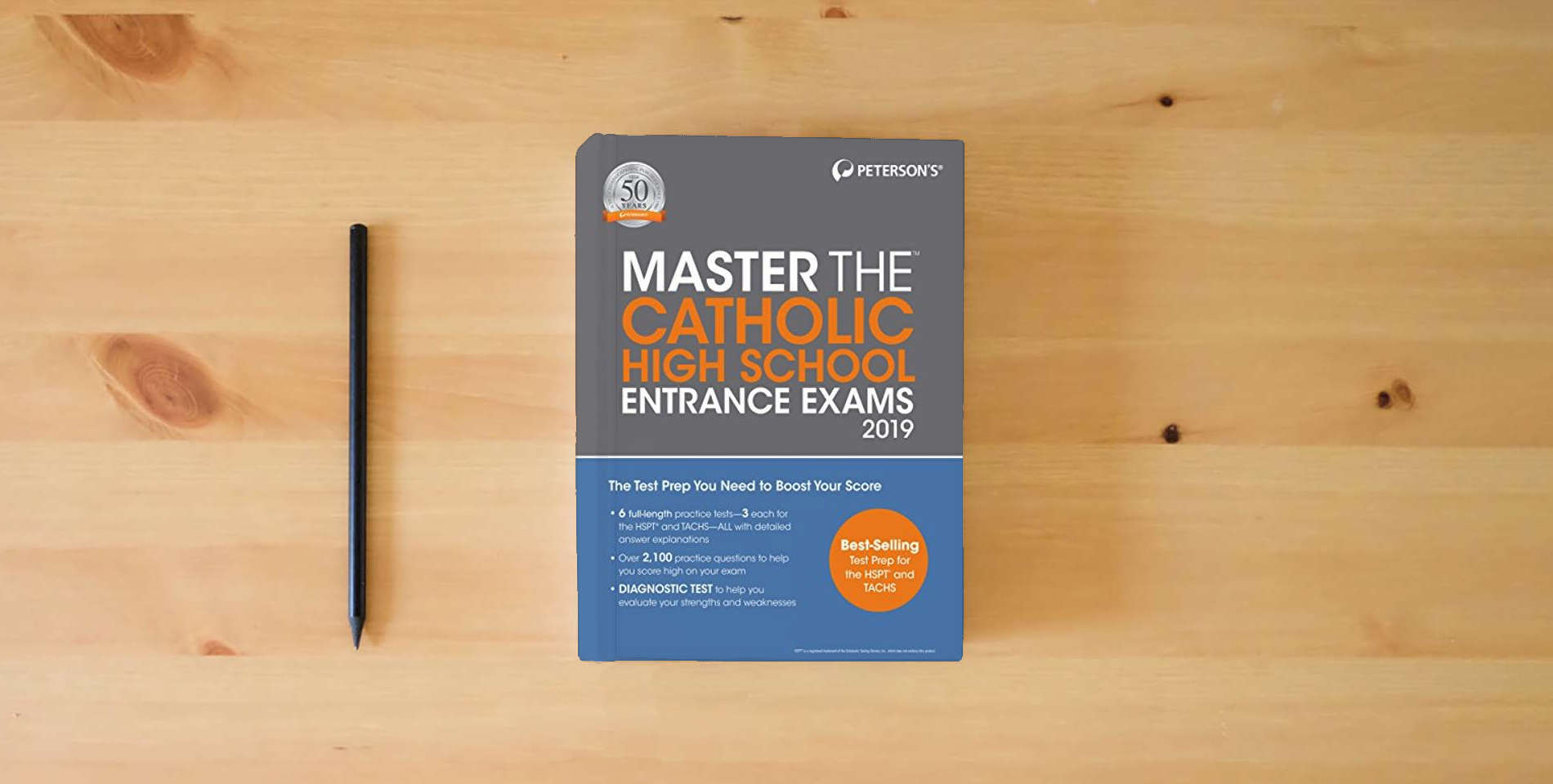 The book Master the Catholic High School Entrance Exams 2019 (Peterson's Master the Catholic High School Entrance Exams) is on the table