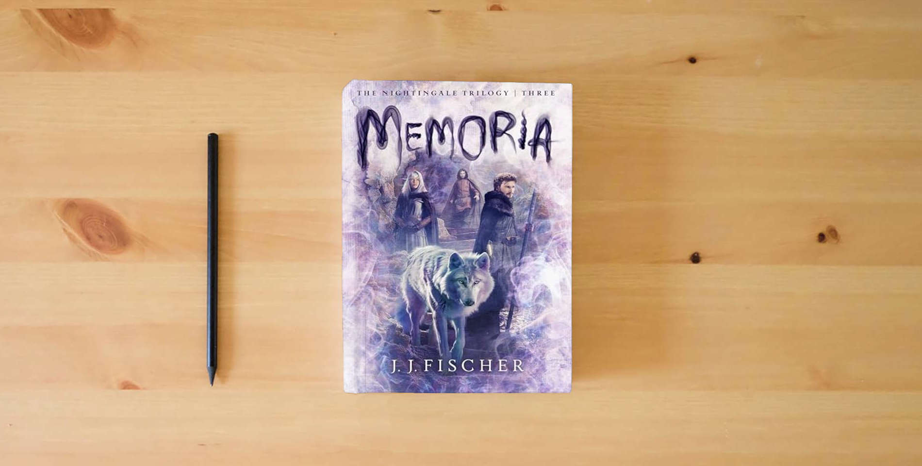 The book Memoria (Volume 3) (The Nightingale Trilogy) is on the table