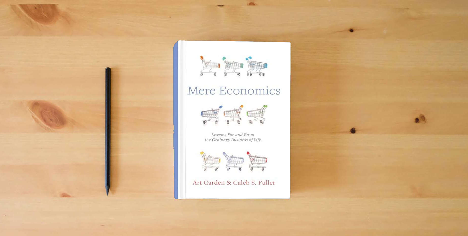 The book Mere Economics: Lessons for and from the Ordinary Business of Life is on the table