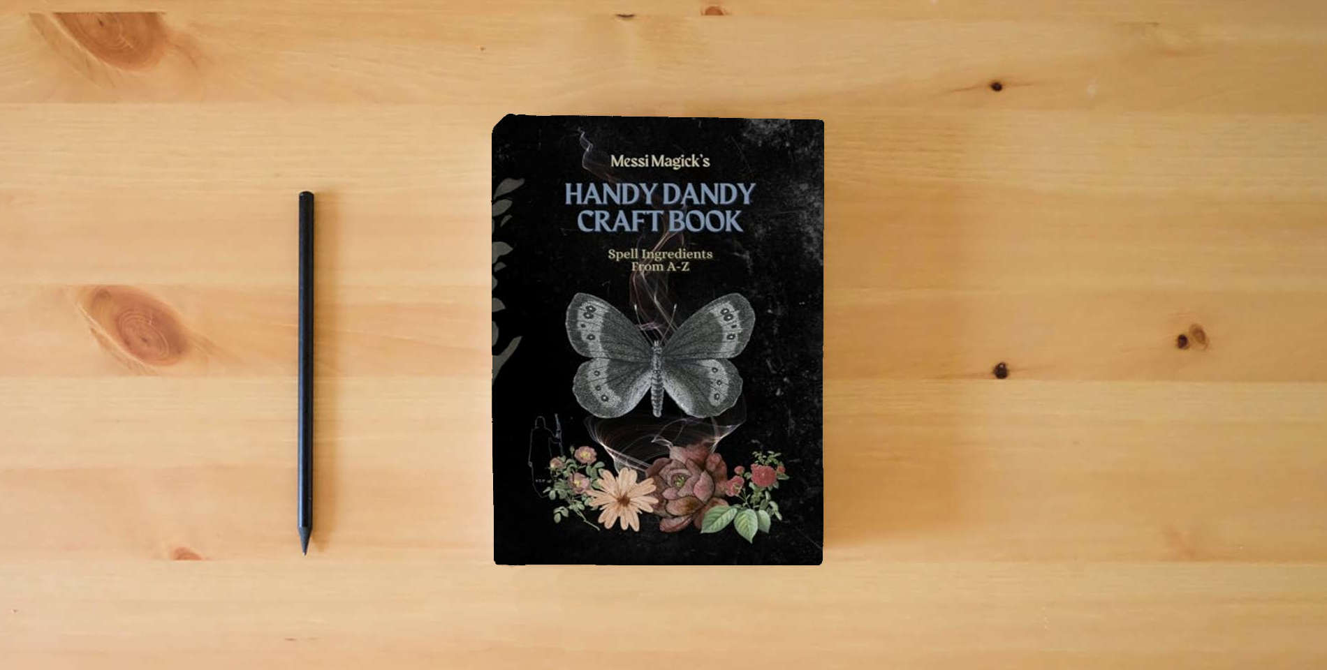 The book Messi Magick's Handy Dandy Craft Book: Spell Ingredients from A to Z is on the table