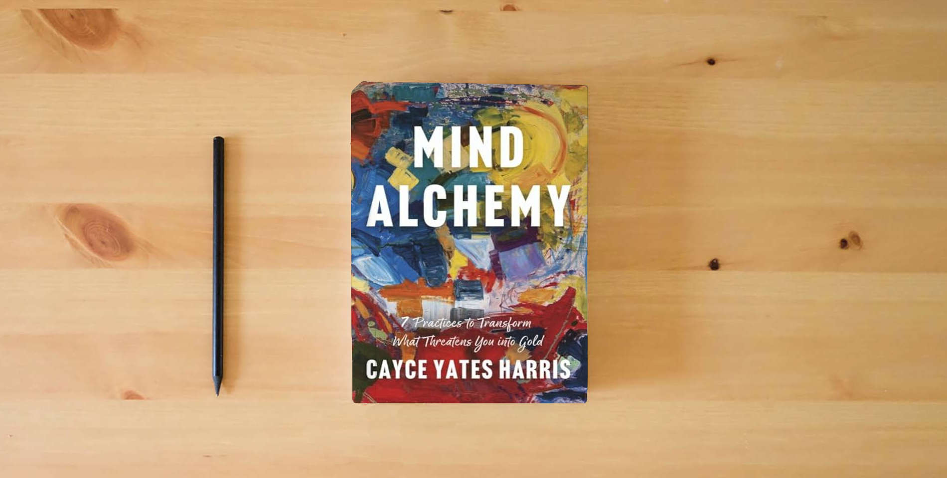 The book Mind Alchemy: 7 Practices to Transform What Threatens You into Gold is on the table