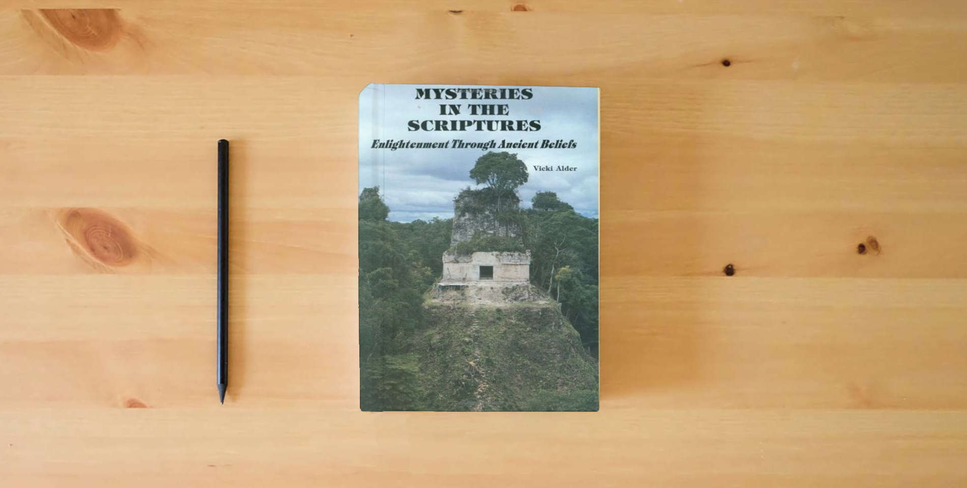 The book Mysteries in the Scriptures, Enlightenment Through Ancient Beliefs is on the table