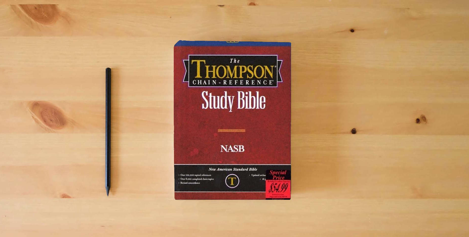 The book NASB - Black Bonded Leather - Regular Size - Thompson Chain Reference Bible (016090) is on the table