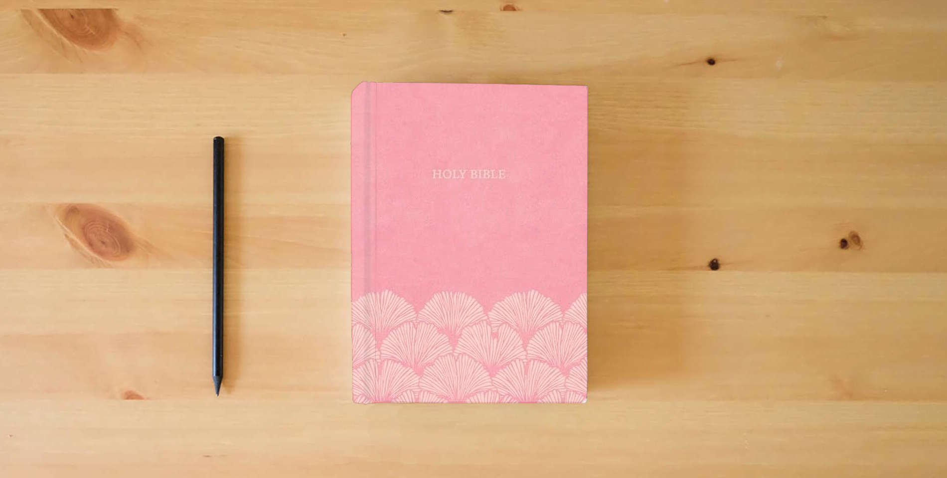The book NASB Large Print Thinline Bible, Value Edition, Soft Pink LeatherTouch, Black Letter, Presentation Page, Sewn Binding, Full-Color Maps, Easy-to-Read Bible Karmina Type is on the table