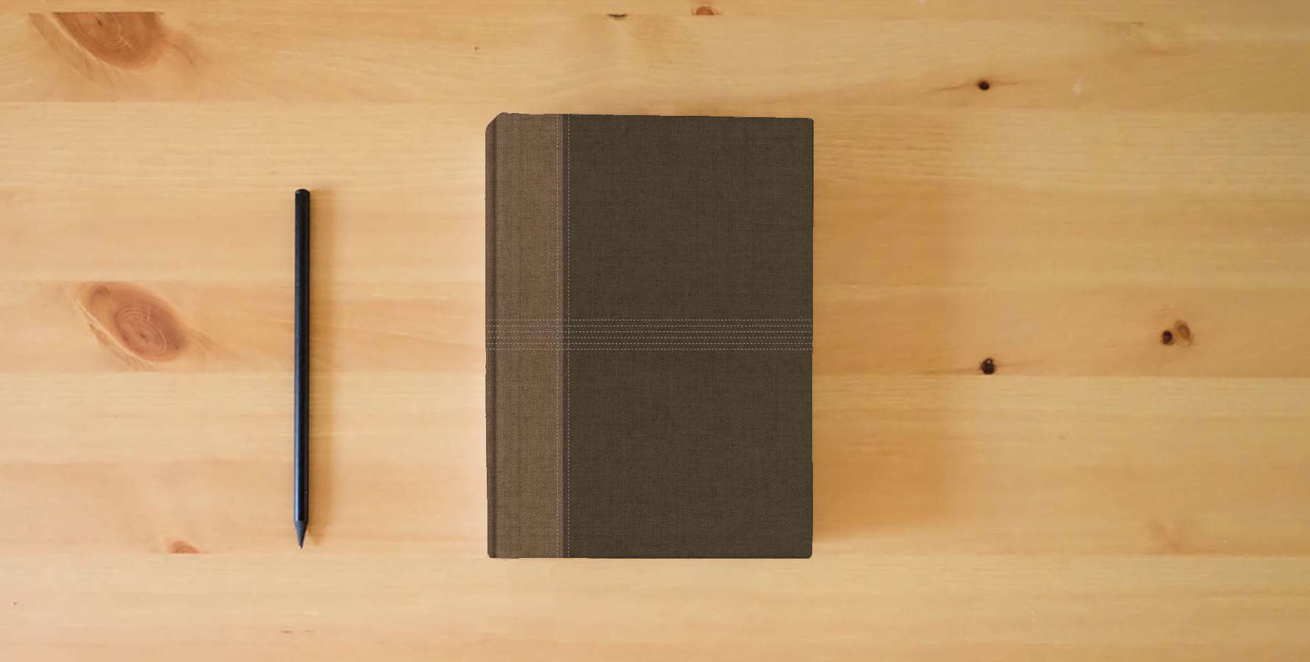 The book NASB Notetaking Bible, Large Print Edition, Brown Cloth Over Board, Single-Column, Black Letter, Wide Margins, Journaling Space, Reading Plan, Sewn Binding, Easy-to-Read Karmina Type is on the table