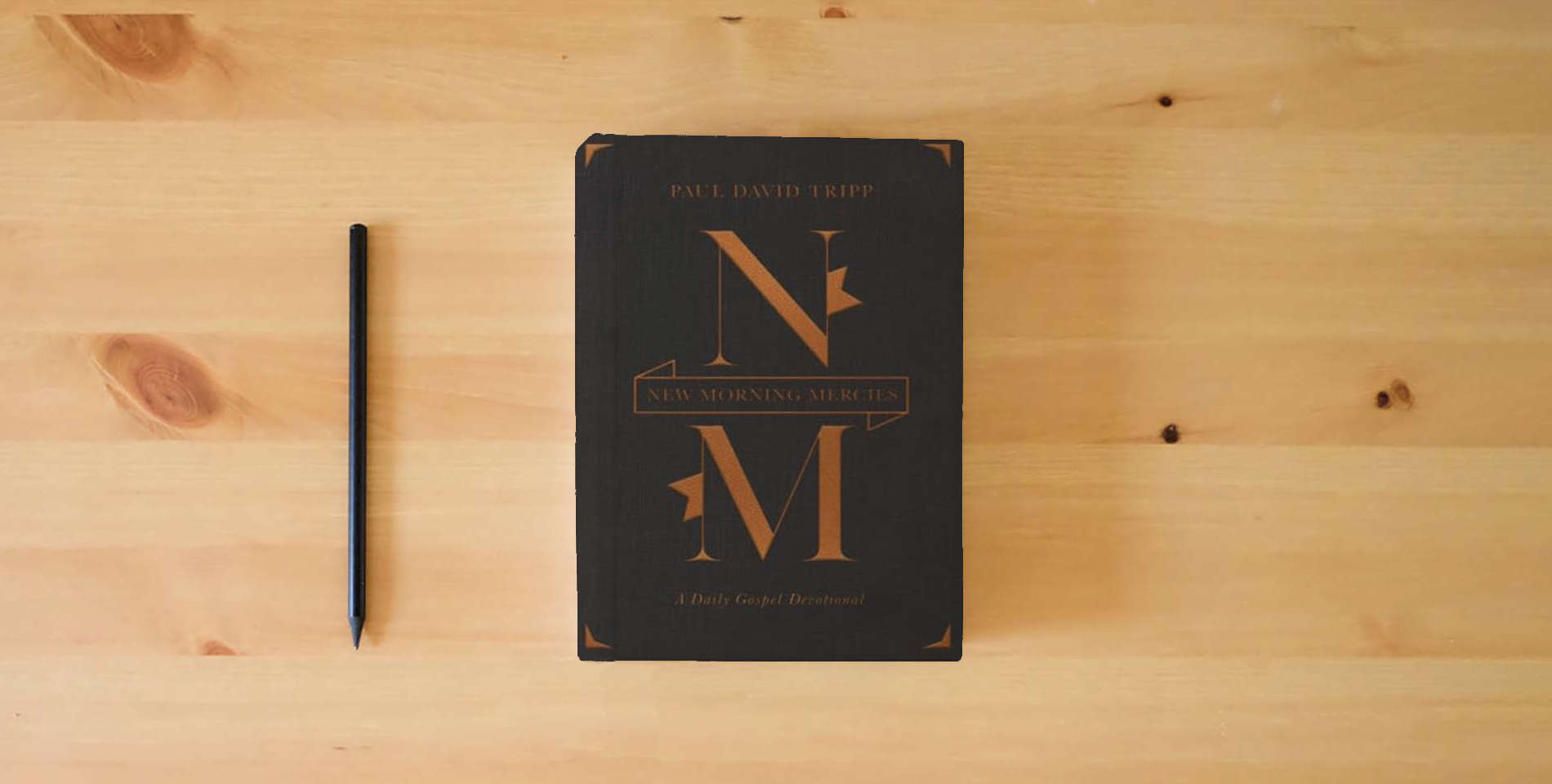 The book New Morning Mercies: A Daily Gospel Devotional (Gift Edition) is on the table