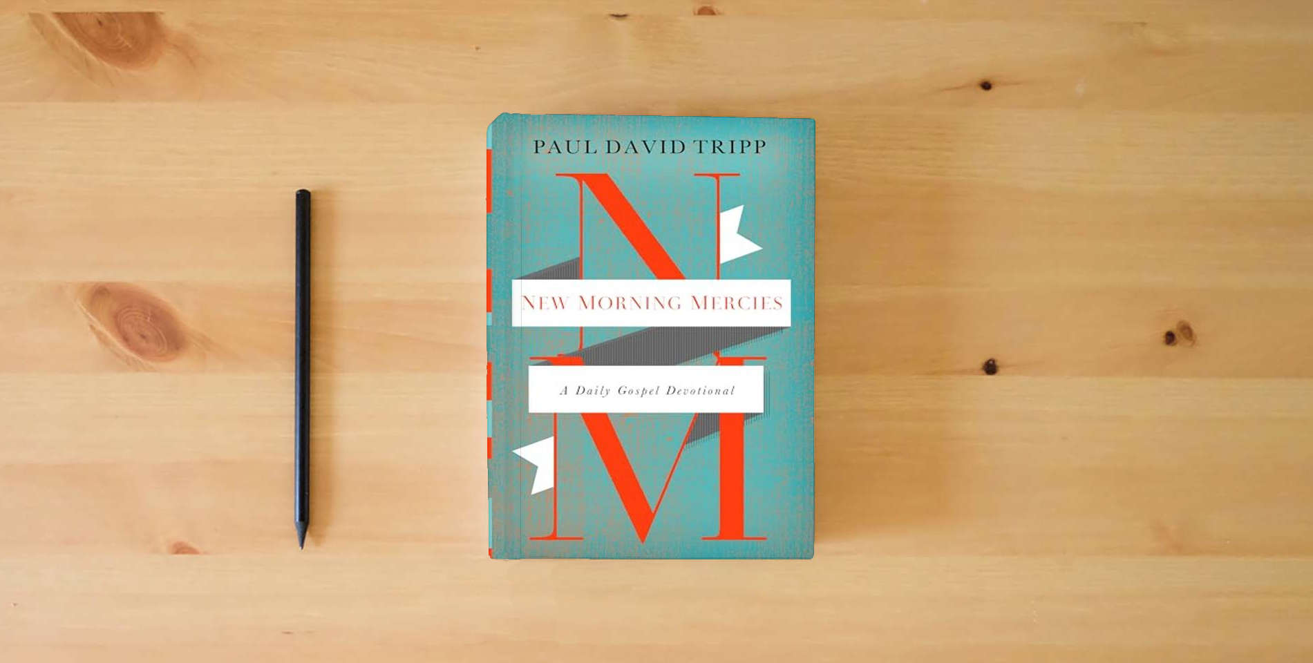 The book New Morning Mercies: A Daily Gospel Devotional is on the table