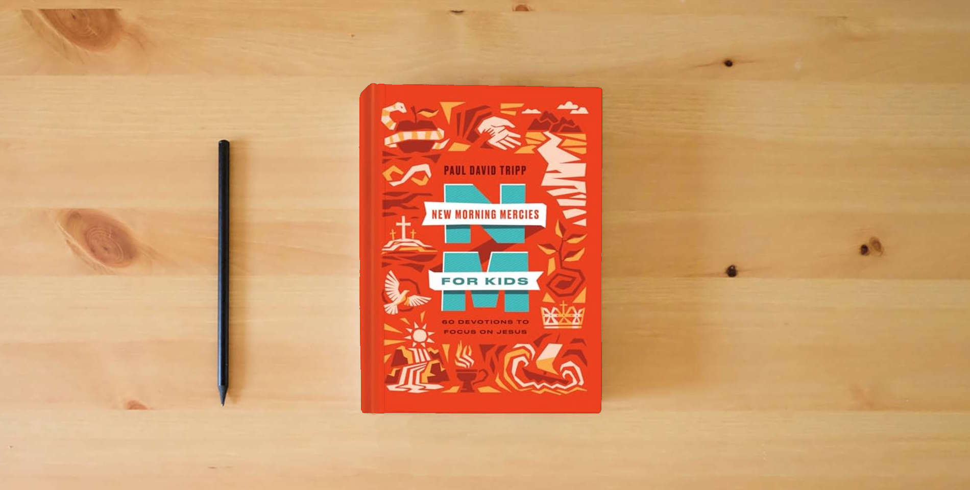The book New Morning Mercies for Kids: 60 Devotions to Focus on Jesus is on the table