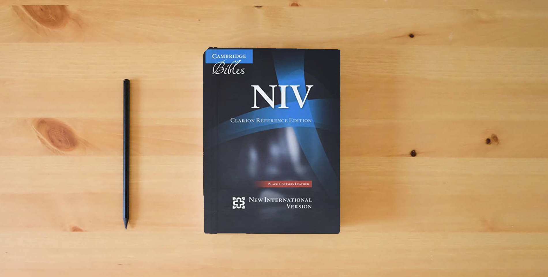 The book NIV Clarion Reference Bible, Black Edge-lined Goatskin Leather, NI486:XE is on the table
