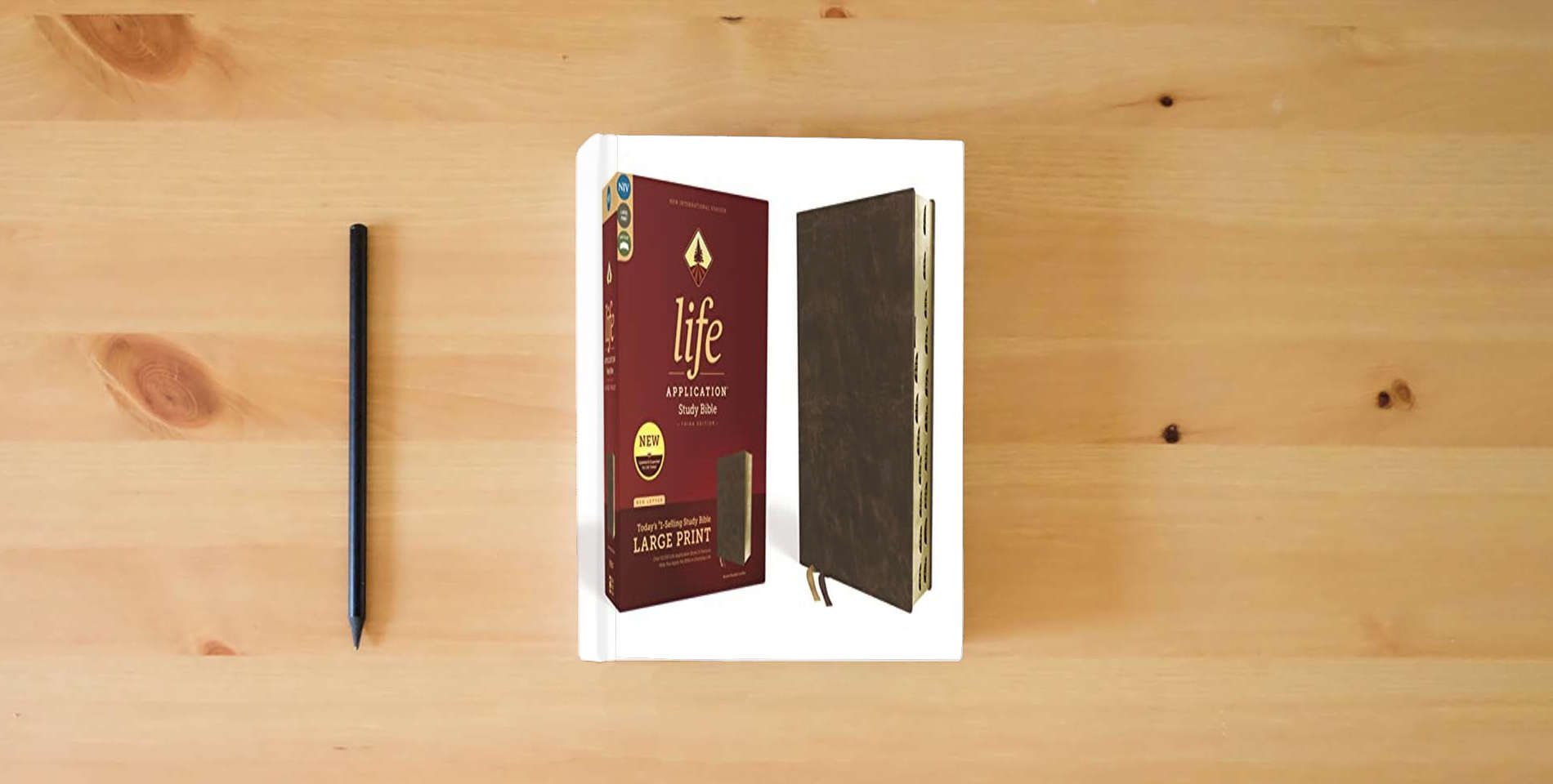 The book NIV, Life Application Study Bible, Third Edition, Large Print, Bonded Leather, Brown, Red Letter, Thumb Indexed is on the table