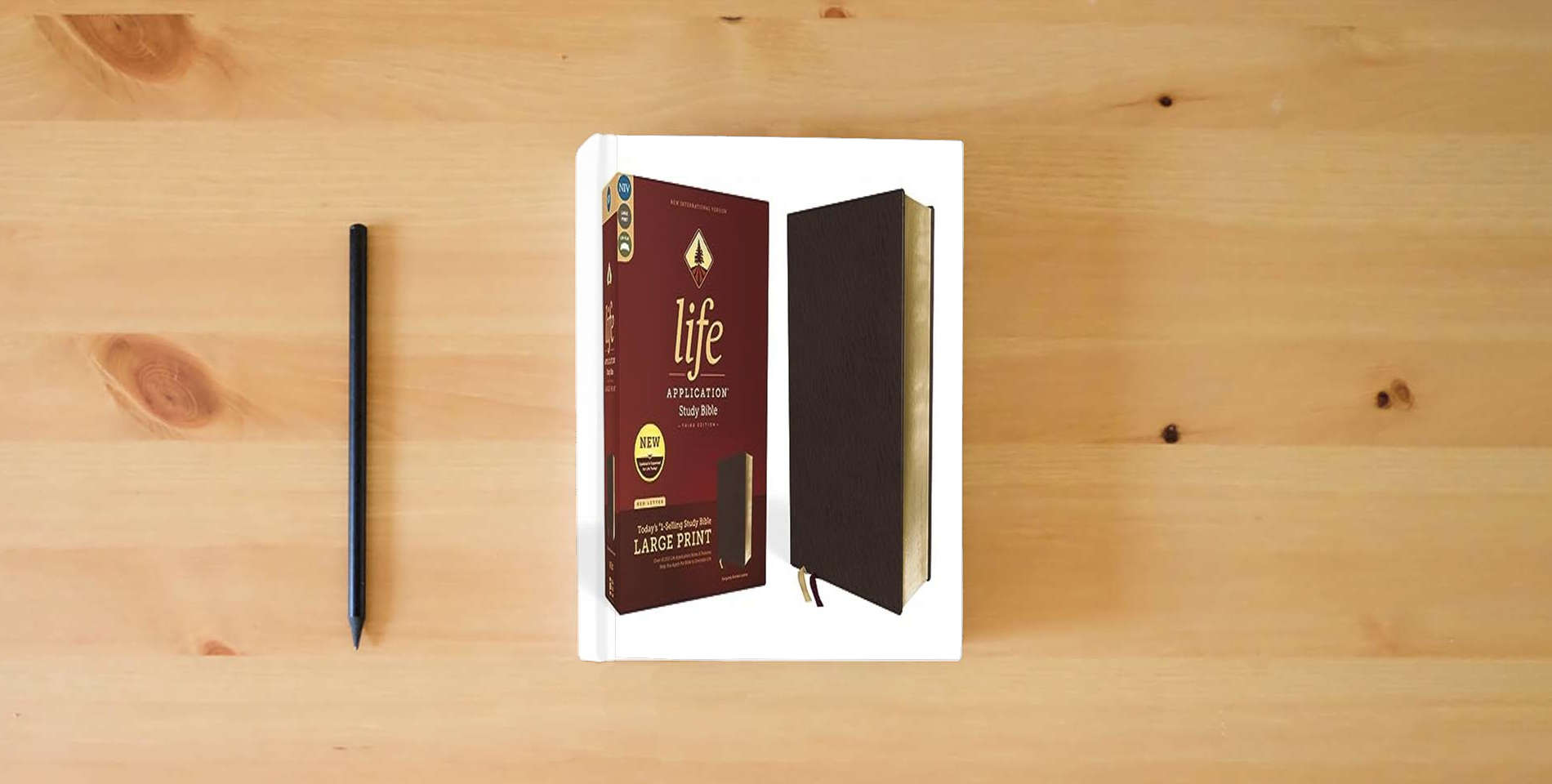 The book NIV, Life Application Study Bible, Third Edition, Large Print, Bonded Leather, Burgundy, Red Letter is on the table