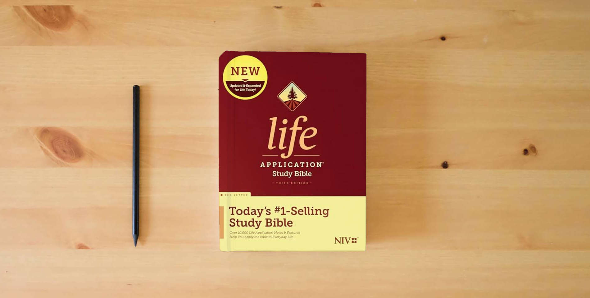 The book NIV Life Application Study Bible, Third Edition (Red Letter, Hardcover) Tyndale NIV Bible with Updated Notes and Features, Full Text New International Version is on the table