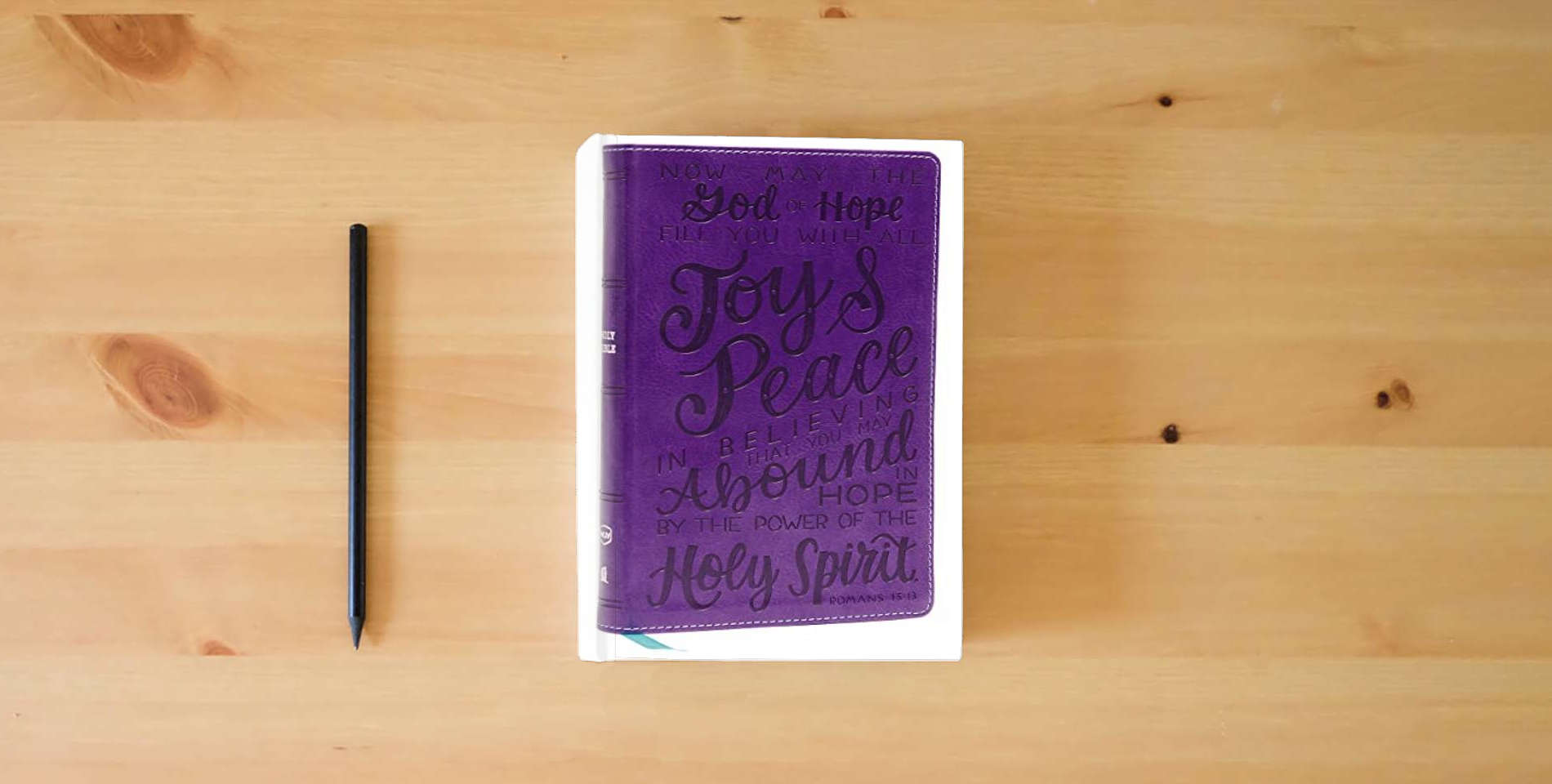 The book NKJV, Holy Bible for Kids, Verse Art Cover Collection, Leathersoft, Purple, Comfort Print: Holy Bible, New King James Version is on the table