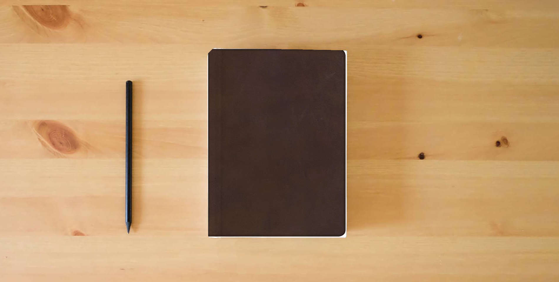 The book NKJV Super Giant Print Reference Bible, Brown Genuine Leather, Indexed is on the table