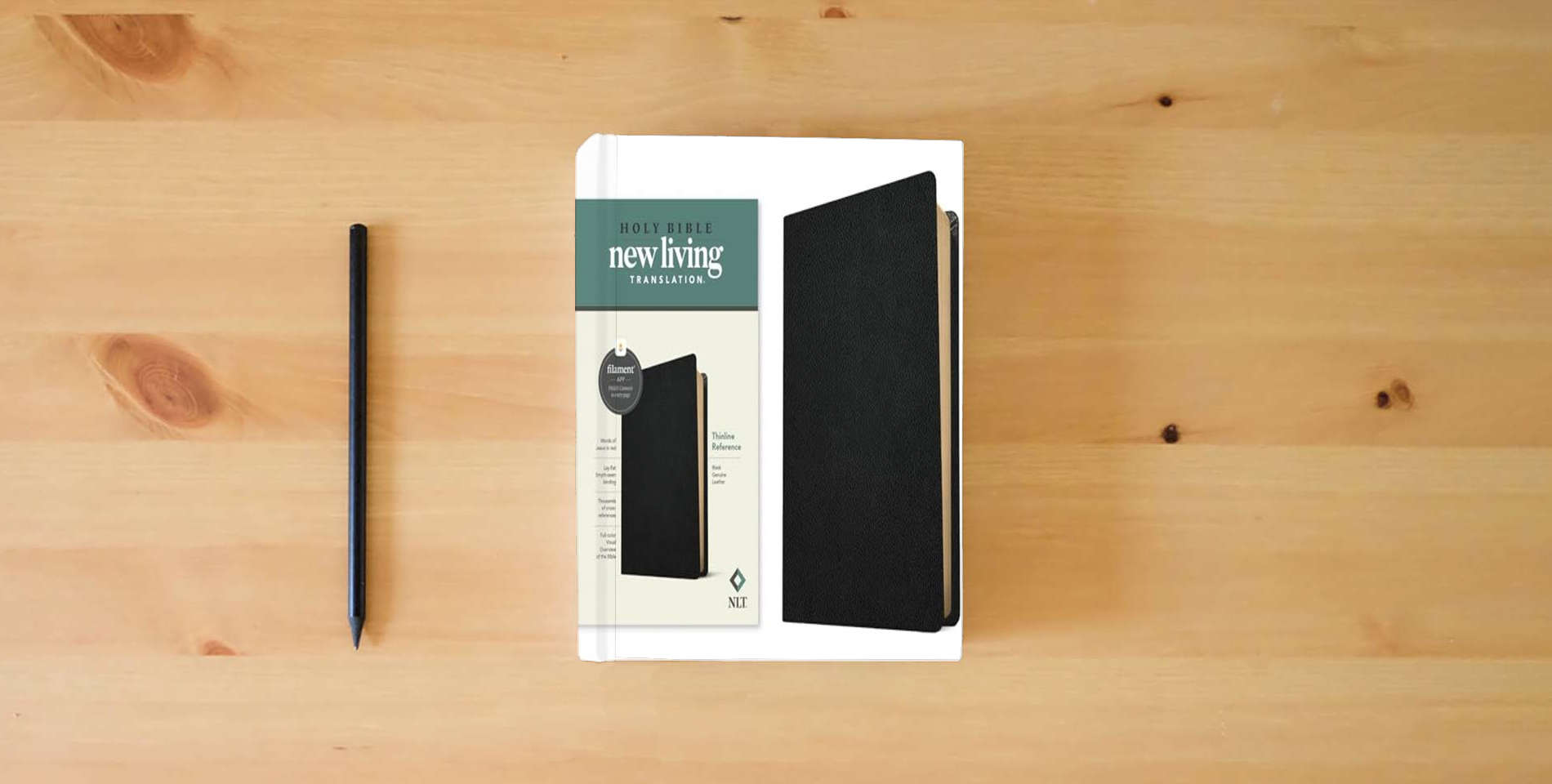 The book NLT Thinline Reference Bible, Filament Enabled (Genuine Leather, Black): Includes Free Access to the Filament Bible App Delivering Study Notes, Devotionals, Worship Music, and Video is on the table