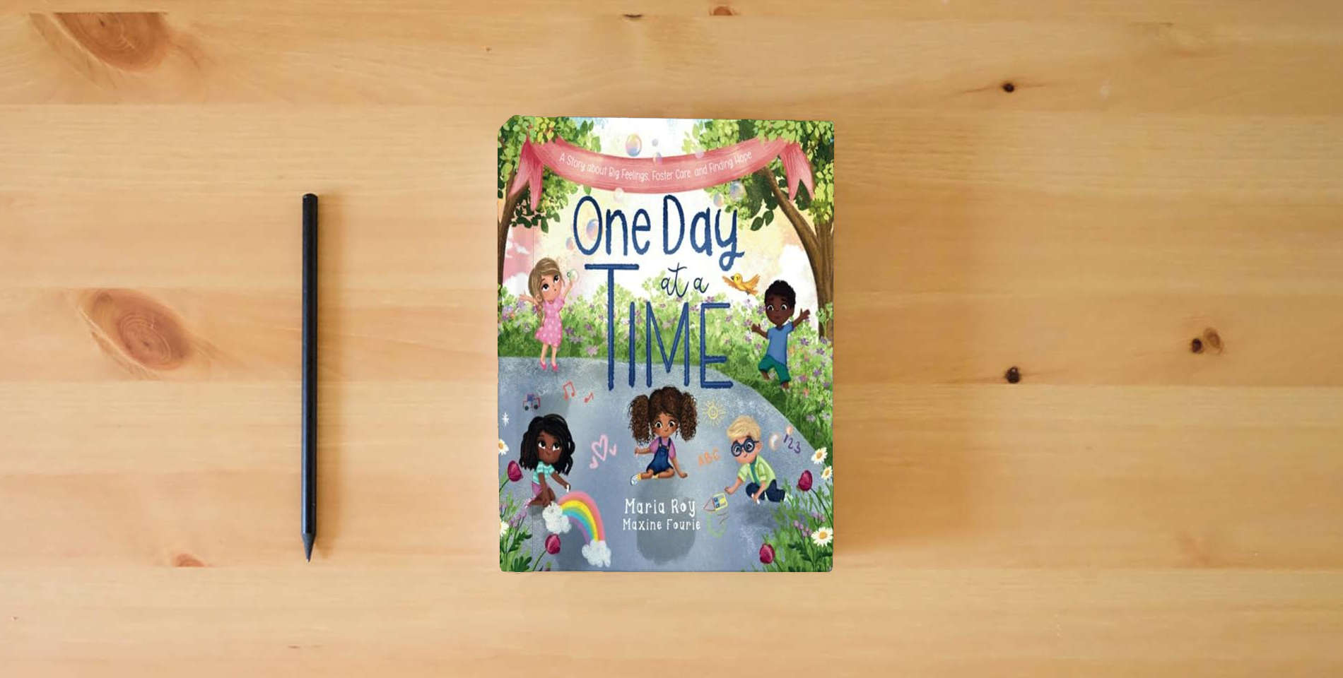 The book One Day at a Time: A Story About Big Feelings, Foster Care, and Finding Hope is on the table