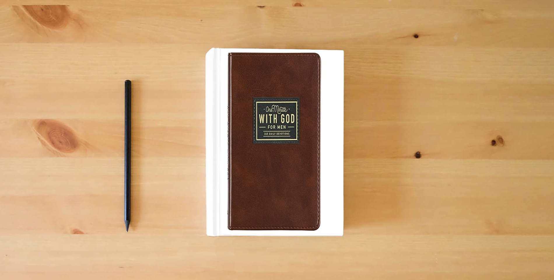 The book One Minute with God for Men 365 Devotions, Brown Faux Leather Flexcover is on the table
