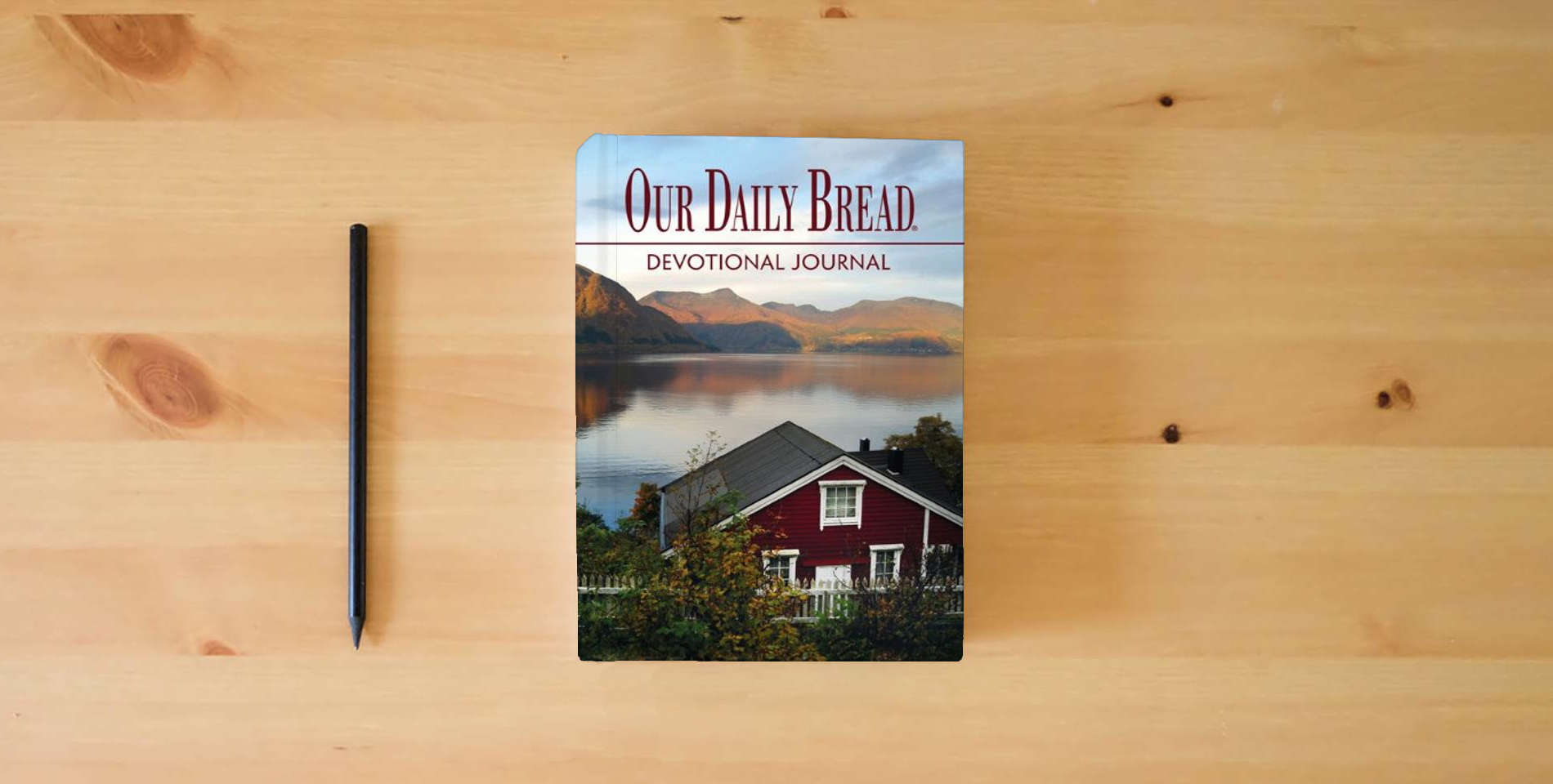 The book Our Daily Bread Devotional Journal is on the table