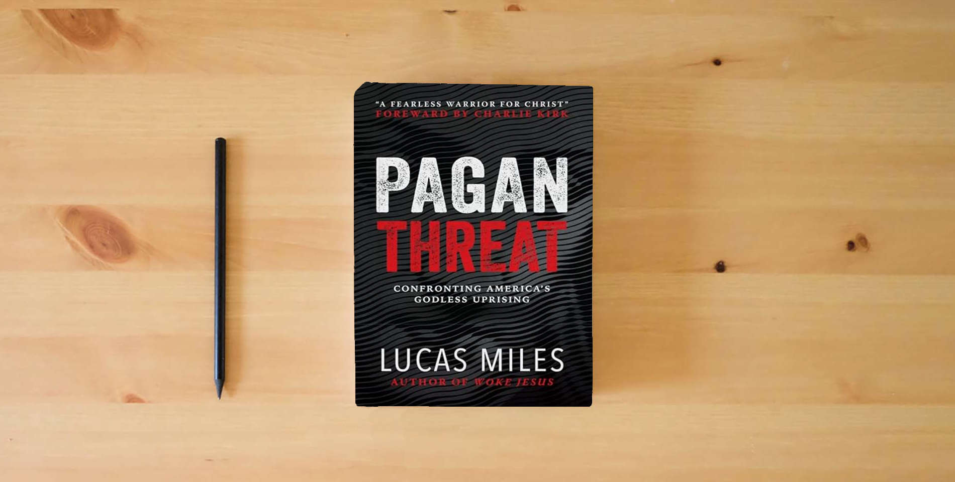 The book Pagan Threat: Confronting America's Godless Uprising with a Foreword by Charlie Kirk is on the table