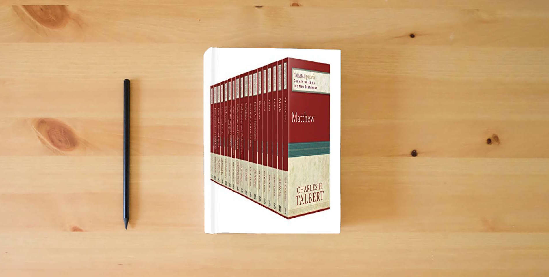 The book Paideia: Commentaries on the New Testament Set is on the table