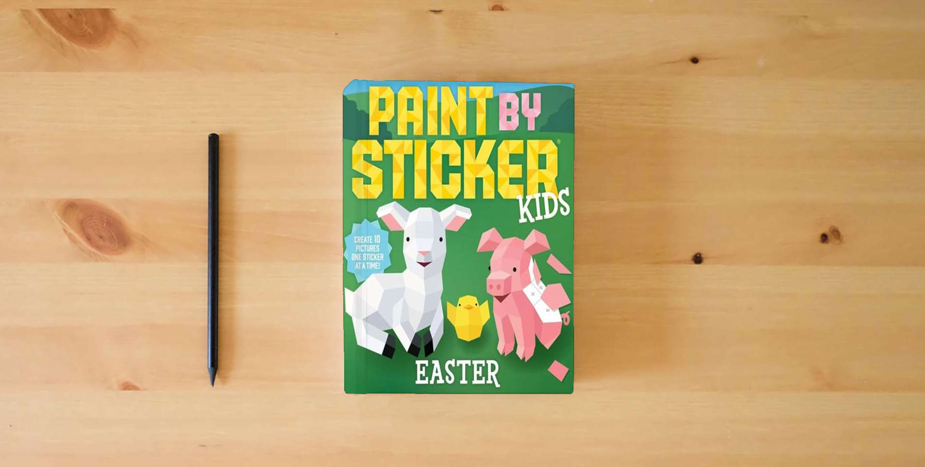 The book Paint by Sticker Kids: Easter: Create 10 Pictures One Sticker at a Time! is on the table