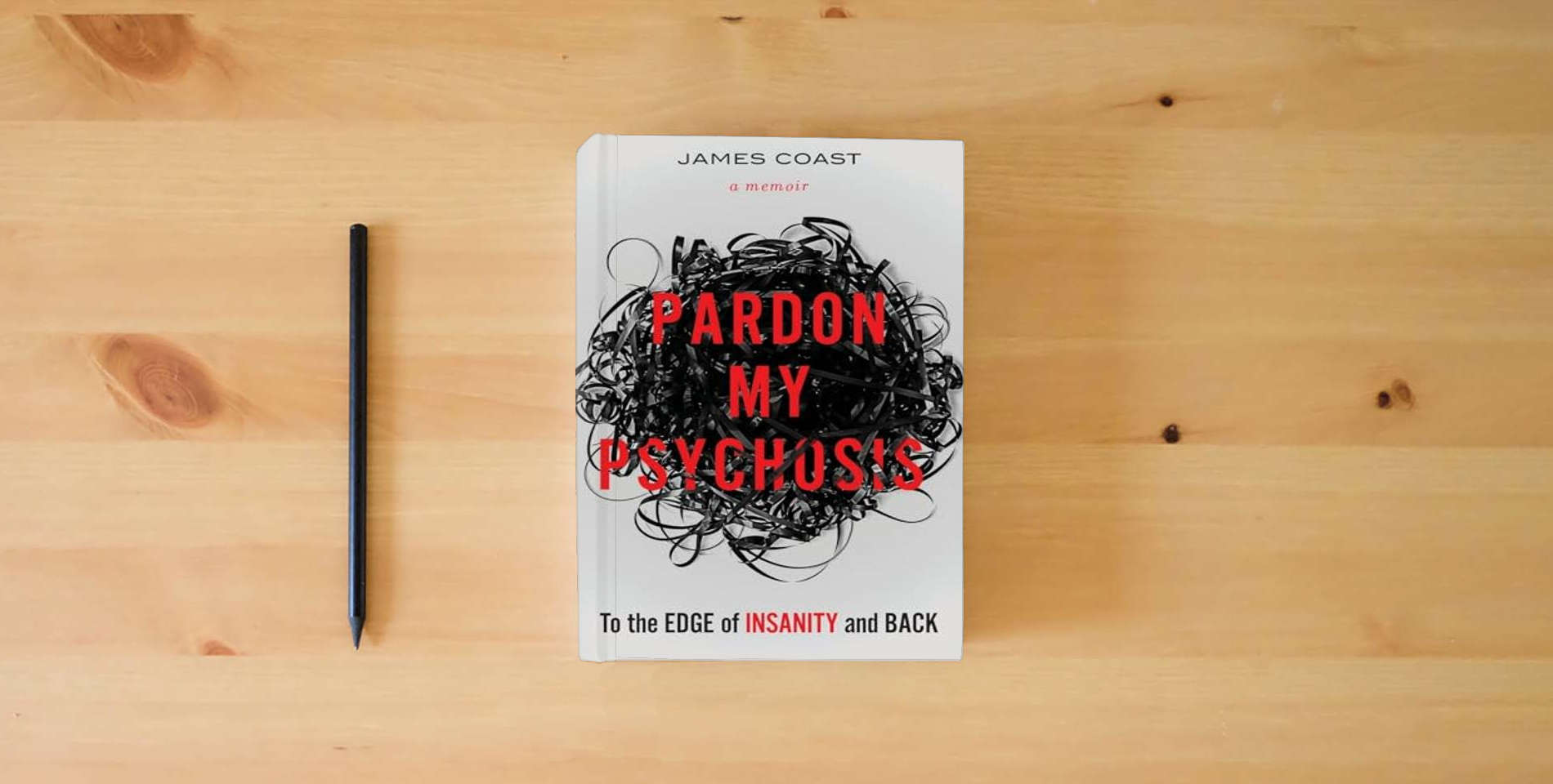 The book Pardon My Psychosis: To the Edge of Insanity and Back is on the table