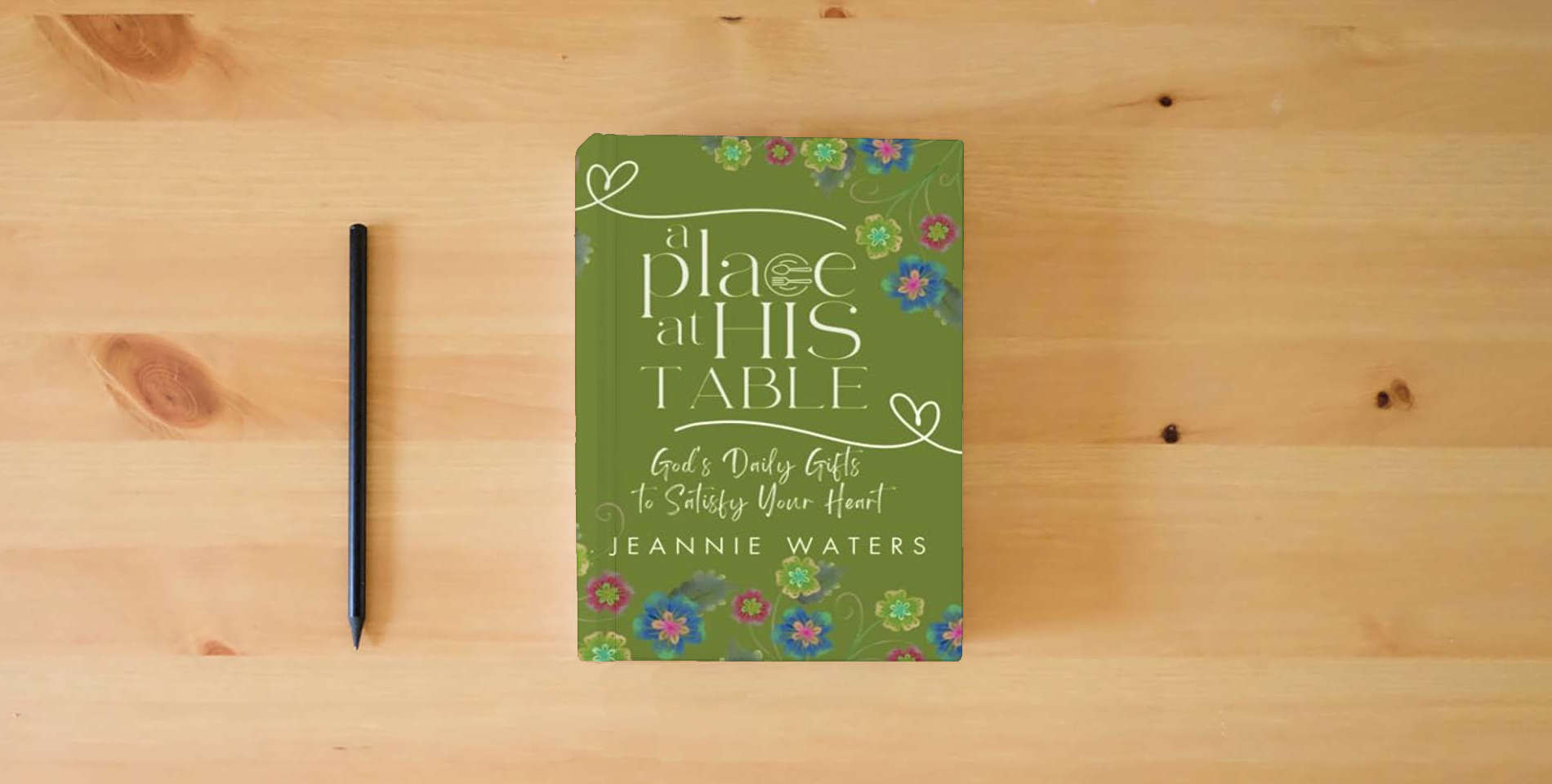 The book A Place at His Table: God's Daily Gifts to Satisfy Your Heart is on the table