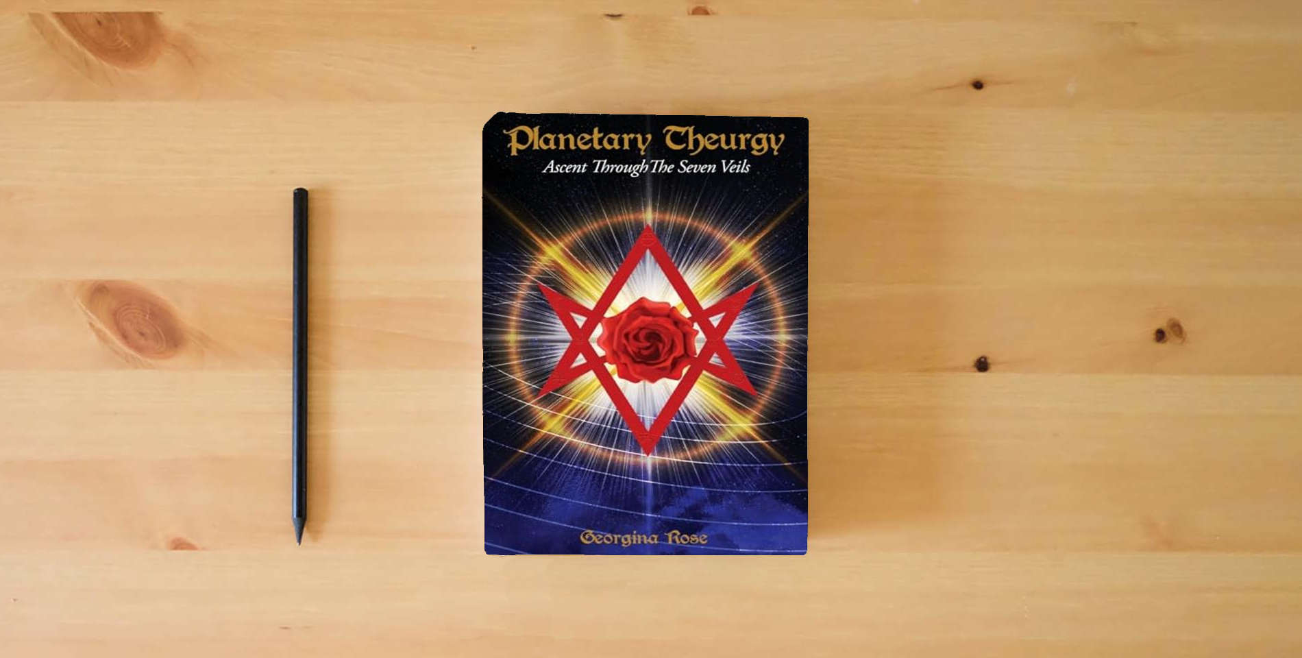 The book Planetary Theurgy: Ascent Through The Seven Veils is on the table
