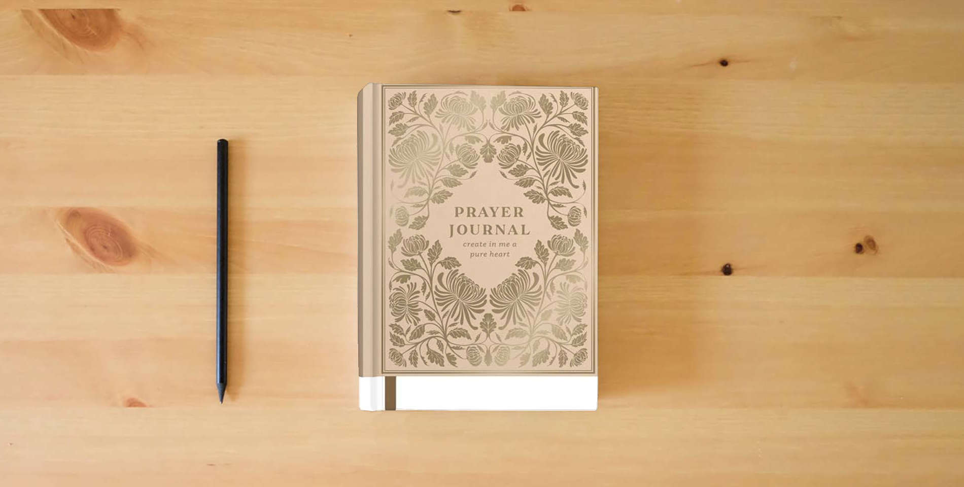 The book Prayer Journal: Create in Me a Pure Heart is on the table