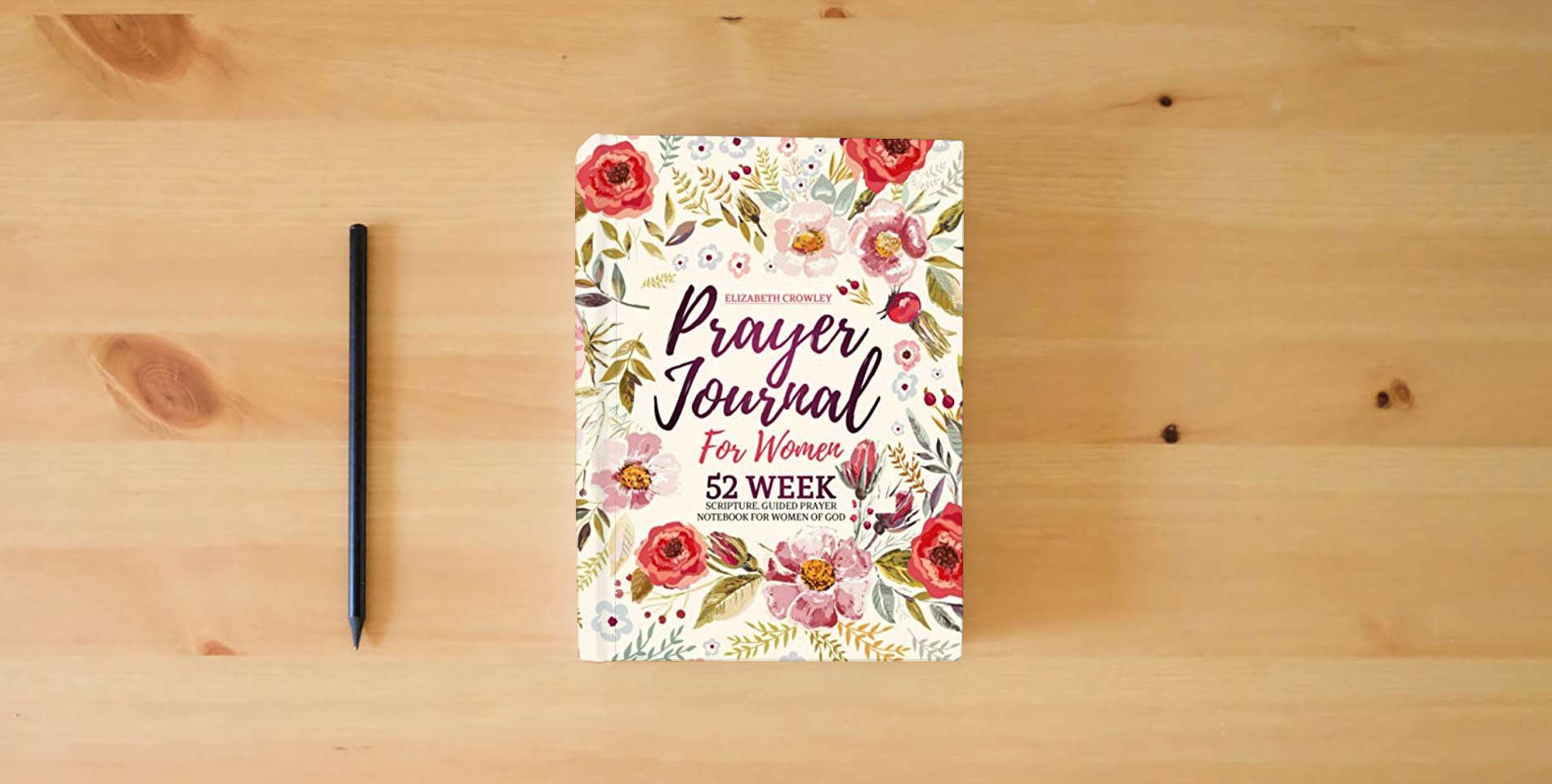 The book Prayer Journal For Women: 52 Week Scripture, Guided Prayer Notebook For Women Of God is on the table