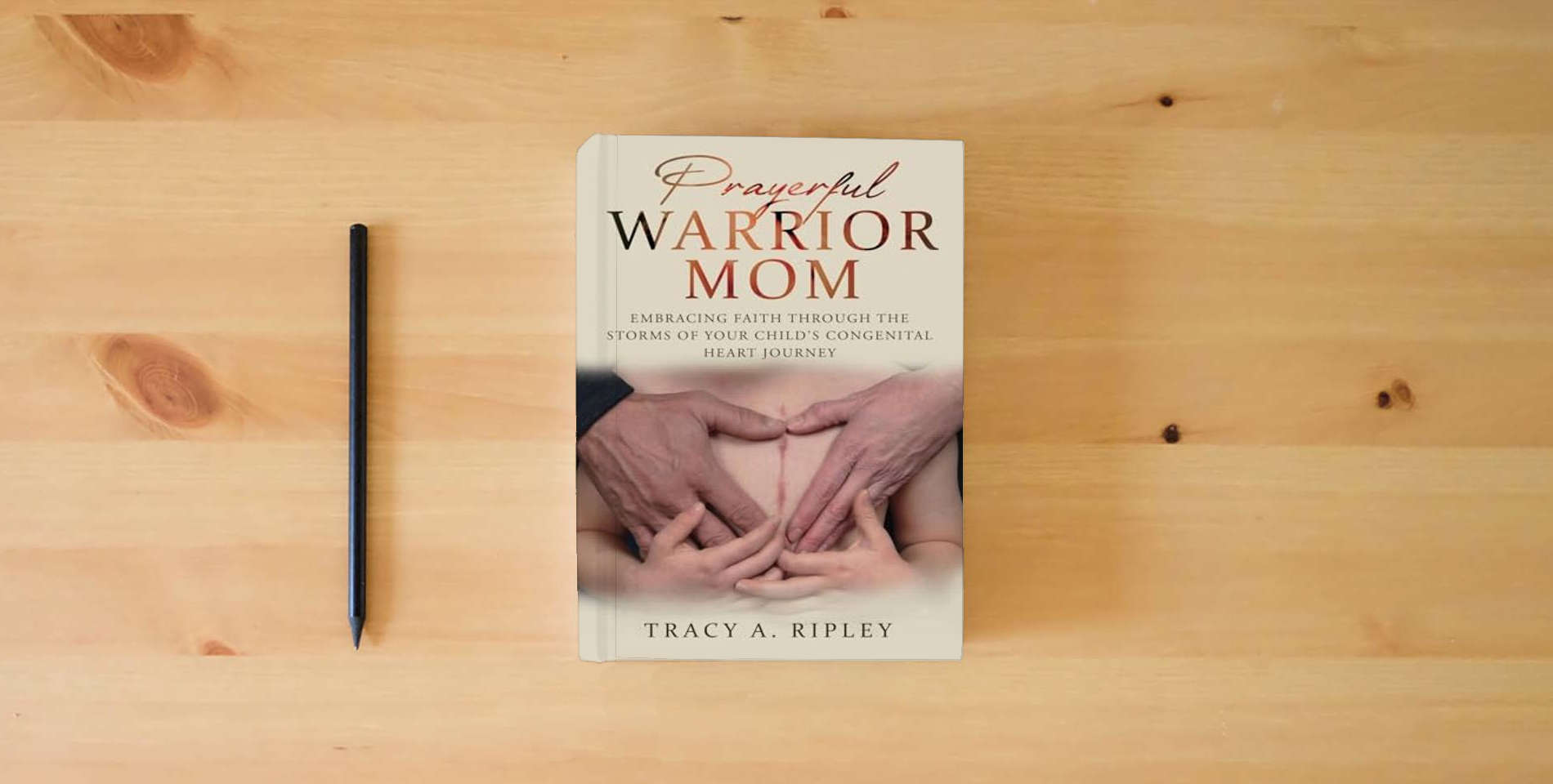 The book Prayerful Warrior Mom: Embracing Faith through the Storms of Your Child's Congenital Heart Journey is on the table