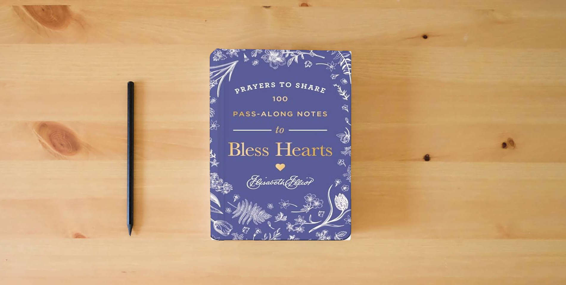 The book Prayers to Share: 100 Pass-Along Notes to Bless Hearts is on the table