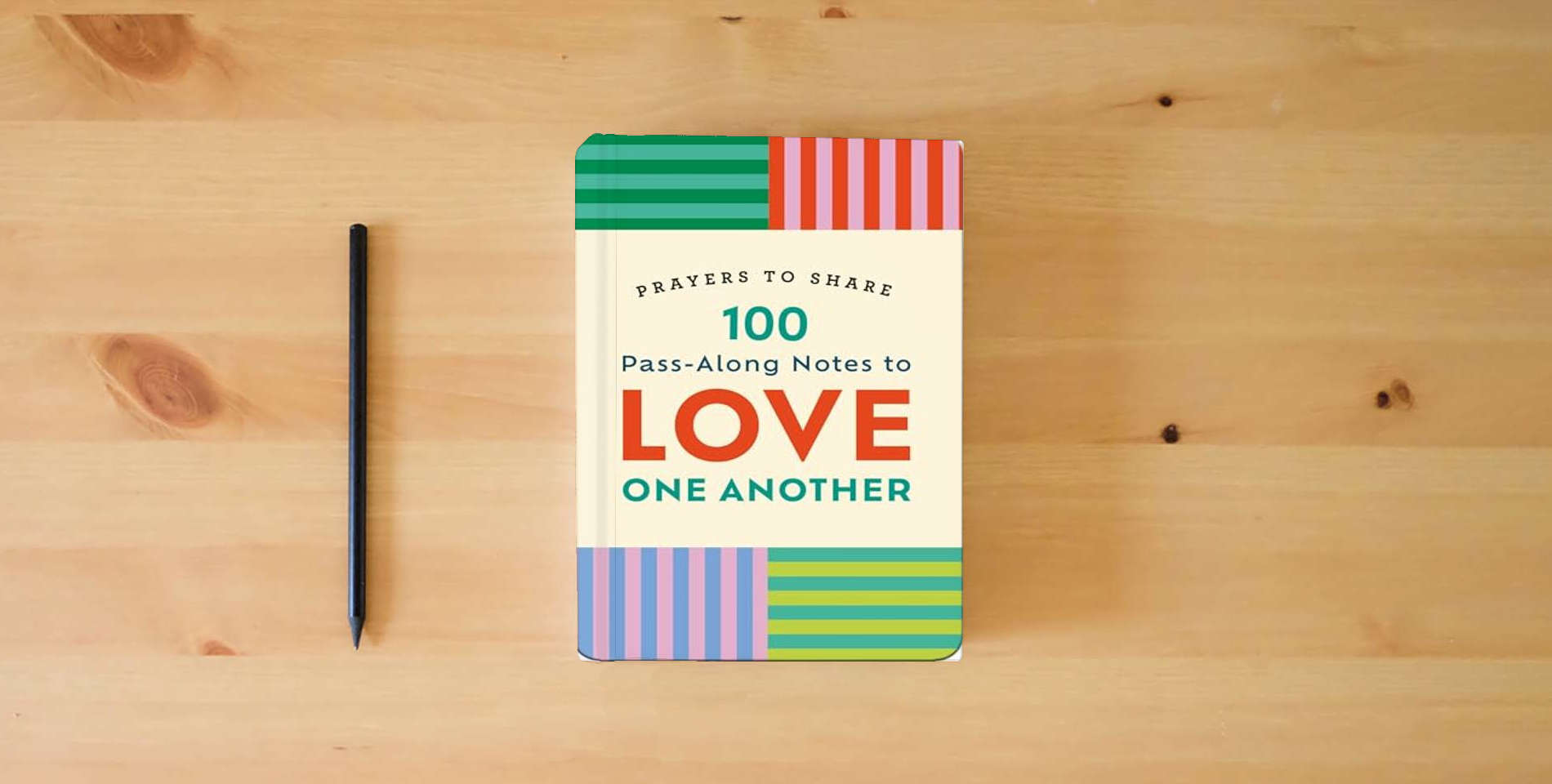 The book Prayers to Share: 100 Pass-Along Notes to Love One Another is on the table