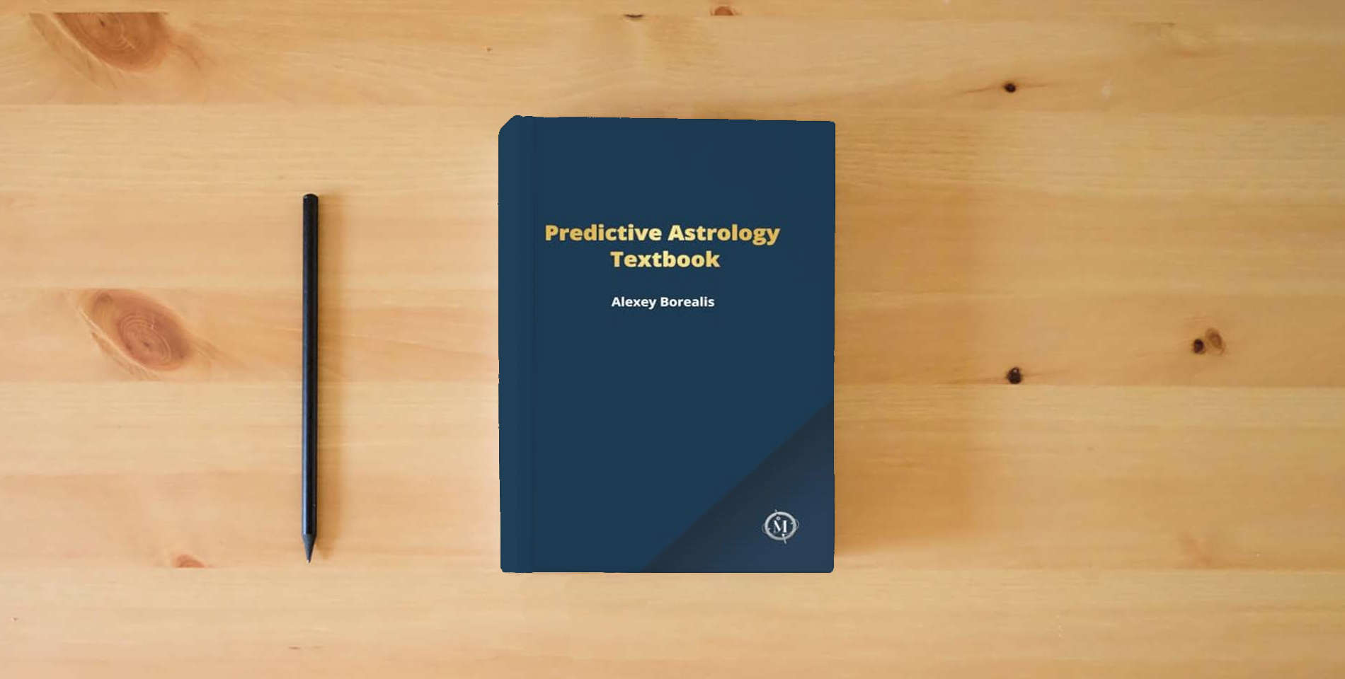 The book Predictive Astrology Textbook is on the table