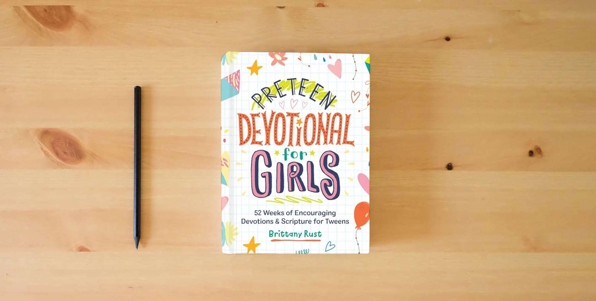 The book Preteen Devotional for Girls: 52 Weeks of Encouraging Devotions and Scripture for Tweens is on the table