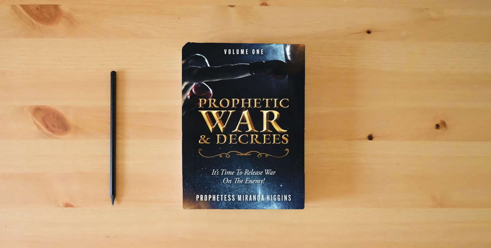 The book Prophetic War and Decrees: It's Time to Release War on the Enemy! is on the table