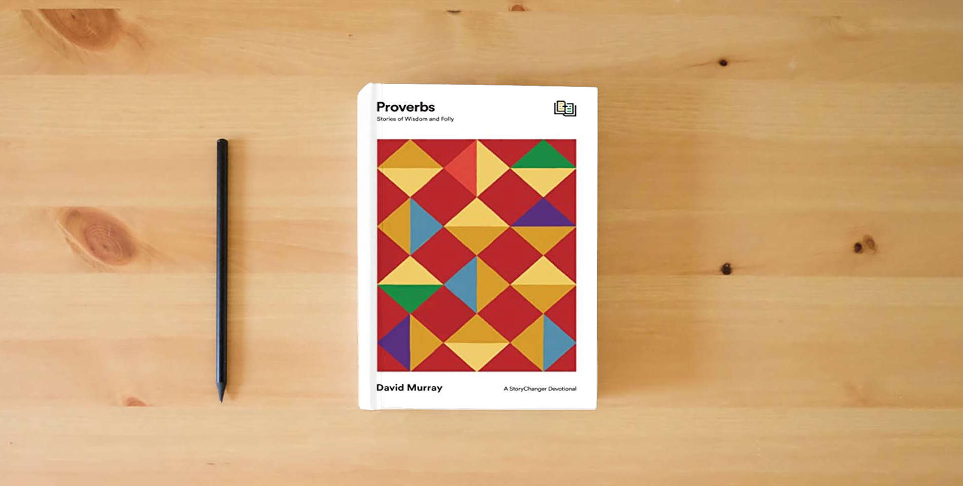 The book Proverbs: Stories of Wisdom and Folly (The StoryChanger Devotional) is on the table